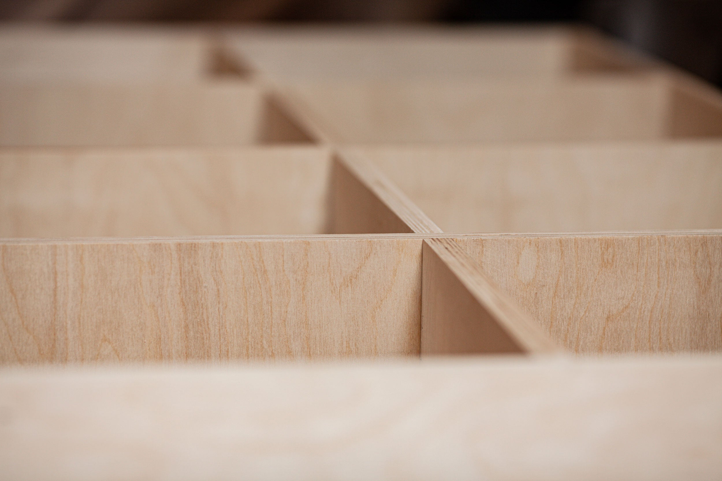 Wooden structure under construction using CNC-cut joinery panels.