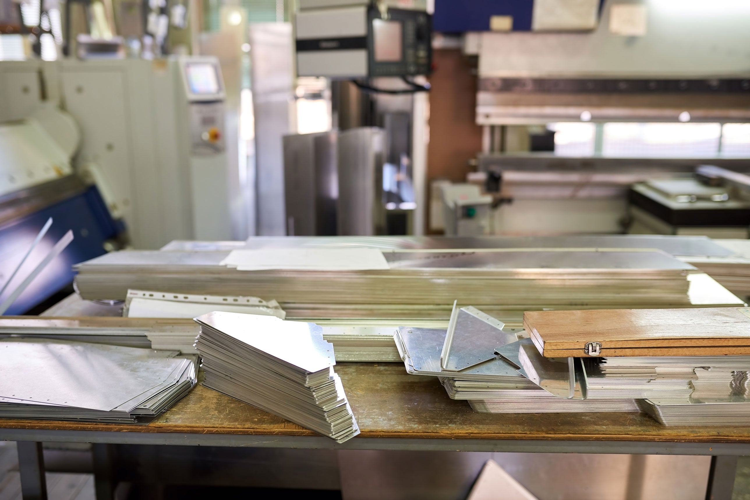 Close-up of sheet metal components used in CNC metalworking.