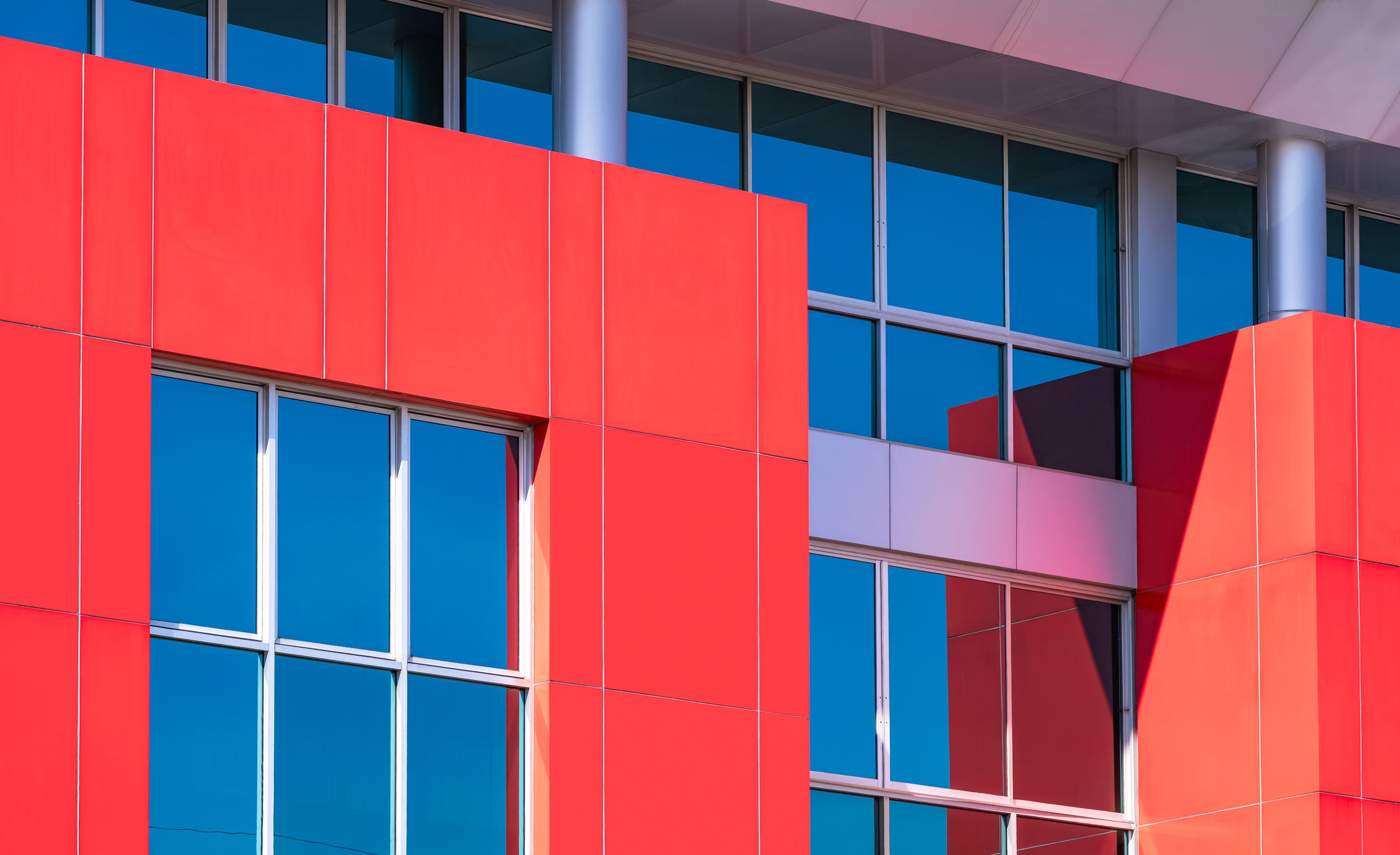 Red and grey aluminium composite sheets for CNC signage fabrication.